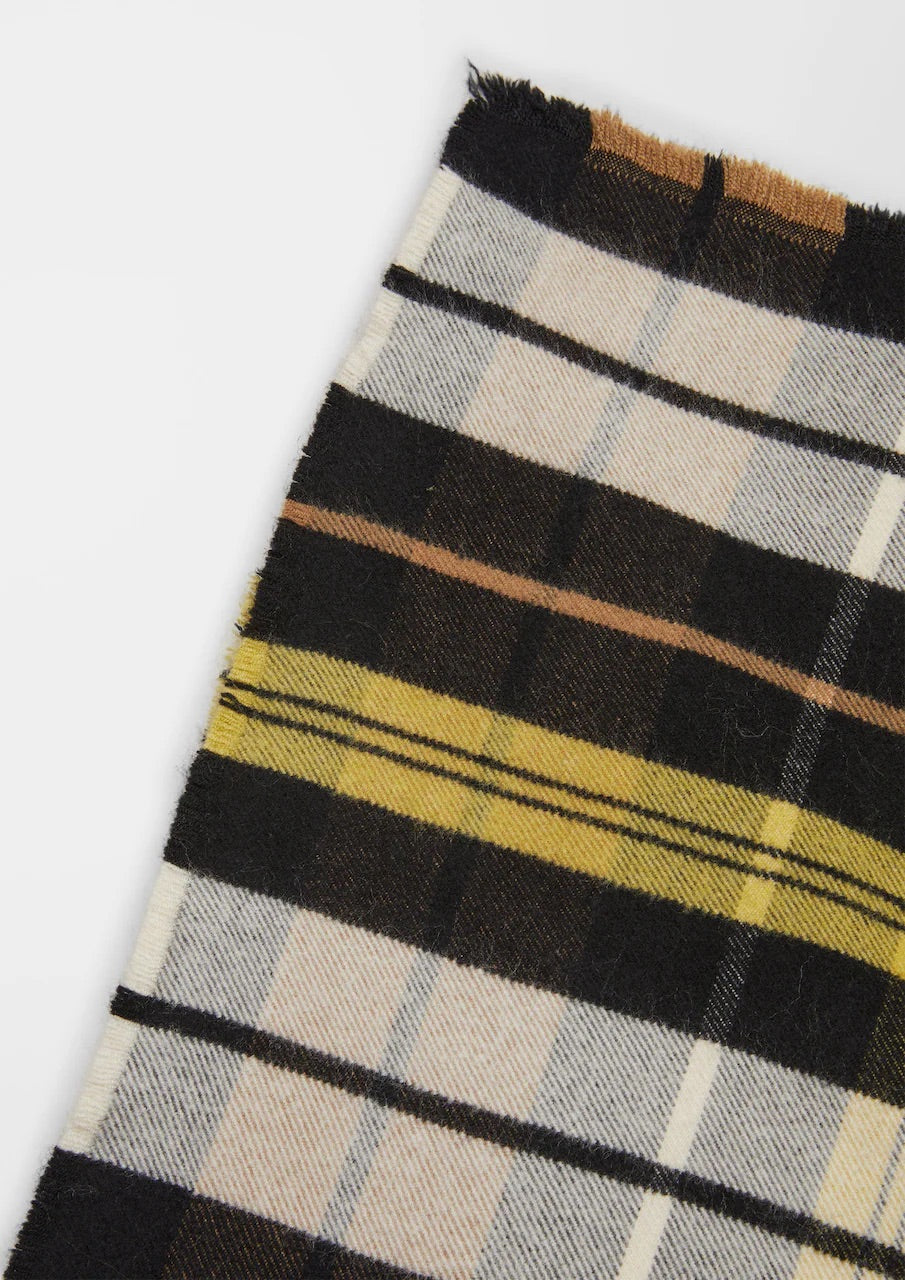 s.Oliver square scarf with black, mustard yellow, cream and grey checks over a black top against a neutral background.